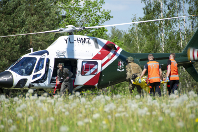 NMPD mediķis un zemessargs uz nestuvēm nes cietušo, lai nodotu Valsts Robežsardzes pilotam un tranportētu ar helikopteru uz slimnīcu. Izspēle mācībās AUSMA