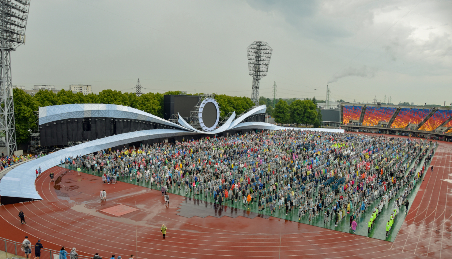 Daugavas stadionā pulcējas Dziesmu un deju svētku dalībnieki, apkārt nedaudz nomākušās debesis